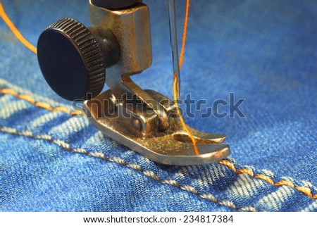 Sewing machine.Sewing of jeans clothes