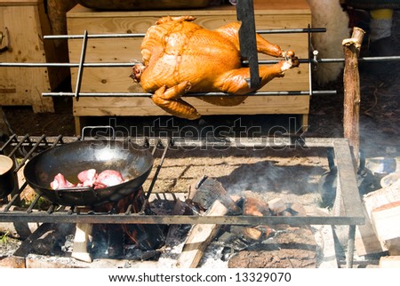 Cooking chicken and meat on fire