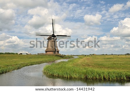 Dutch Windmill , Mill , Agricultural Building with water, pasture and cloudy sky