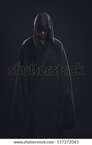 Portrait Of A Man In A Black Robe On A Dark Background