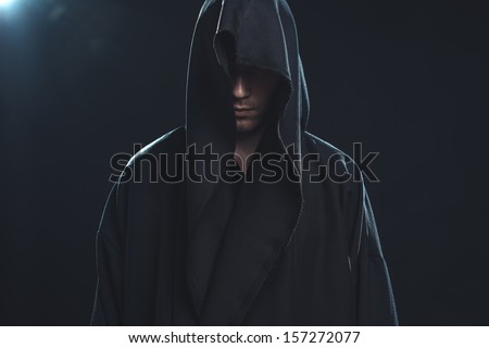 Portrait of a Man in a black robe on a dark background