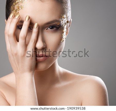 pretty girl with golden make-up art covers eyes
