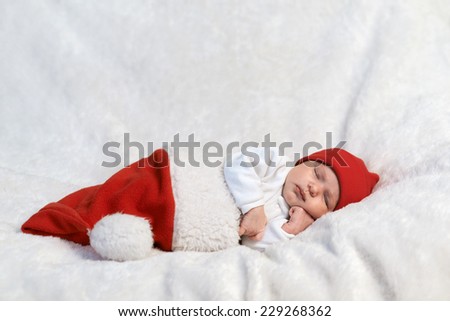 serious baby sleeping in Santa hats