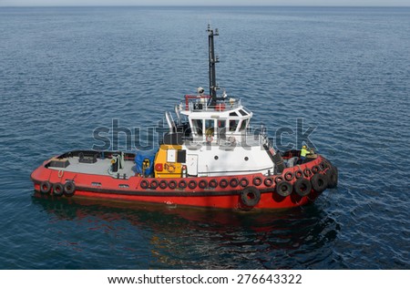 Red tug boat on the water
