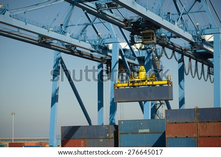large crane moves the metal container