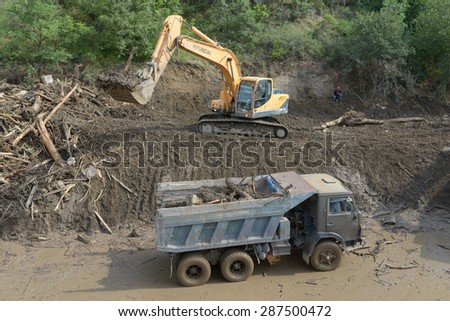 Georgia, Tbilisi, 15 june 2015: excavator clears debris from the road due to flooding