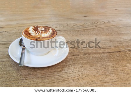 cup of coffee with rose coffee art on top