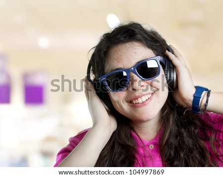 pretty young woman listening to music with sun glasses.