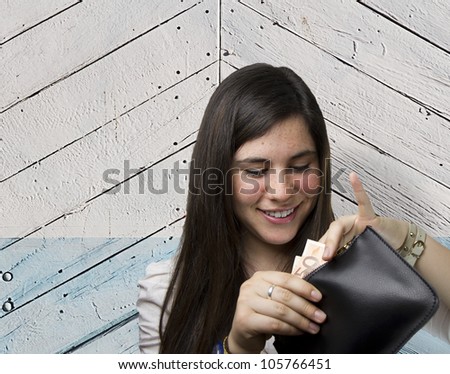 pretty woman with money over wooden background