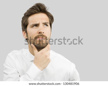 young handsome man doubting isolated over gray background young handsome man doubting isolated over gray background