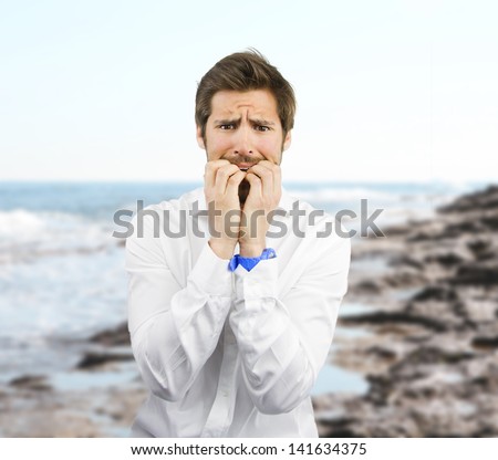 young man afraid in the beach