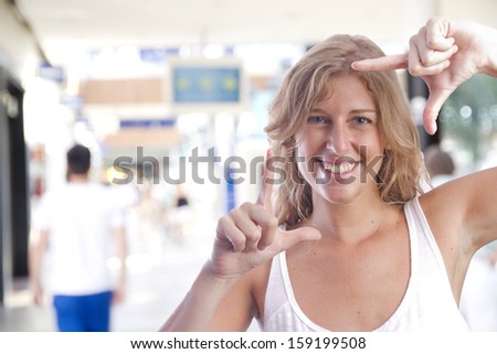 young woman frame gesture in a shopping center