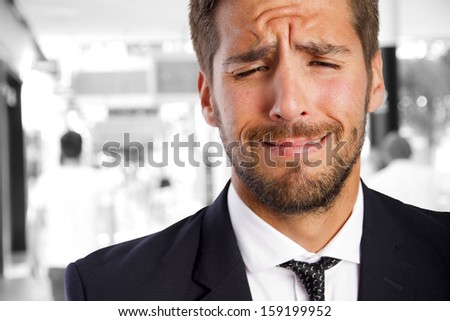 young businessman crying in a company