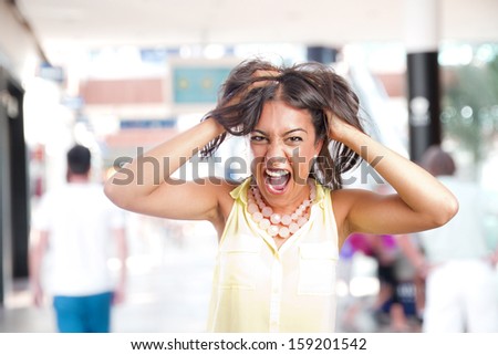 crazy young girl shouting in a shopping center