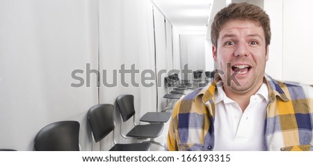 young surprised  man in office or waiting room