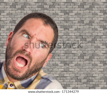 young scared man on brick wall background