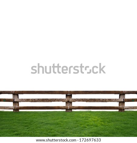 wooden fence in green grass meadow