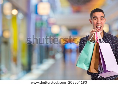 happy young man with shopping bags