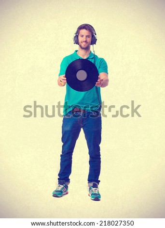 young boy listening music and holding a vinyl