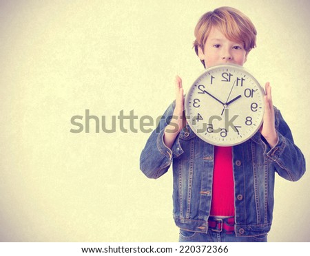 Child holding a clock