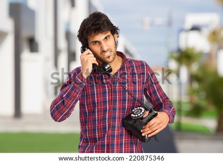cool indian man speaking on telephone
