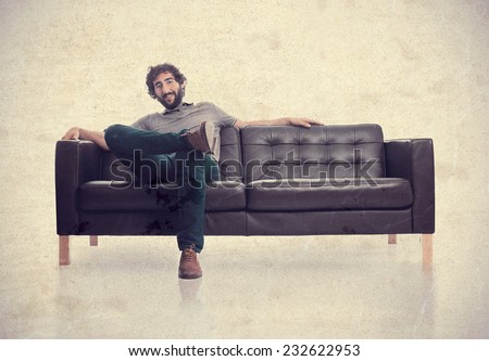 young satisfied man in a sofa