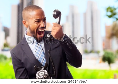 young cool black man shouting at phone