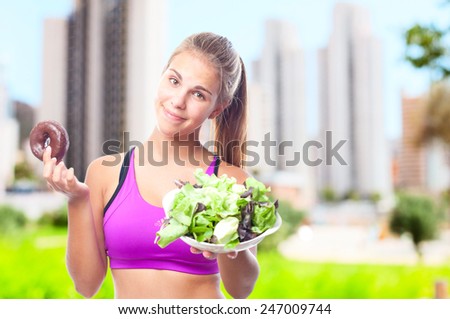 young cool woman with donut and salad