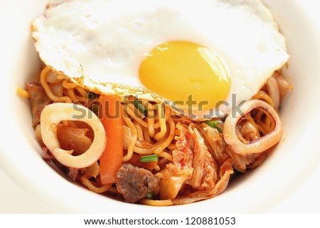 Japanese homemade cooking Vegetable and calamari spicy fried noodle with fried egg