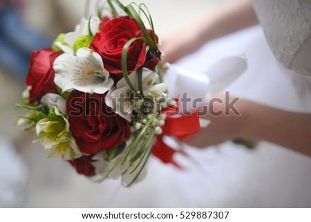 Wedding bouquet in bride\'s hands.