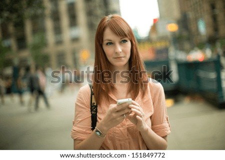 Caucasian woman female using iphone cellphone smartphone walking streets New York City