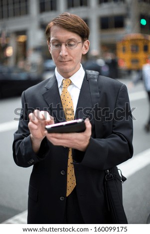 Caucasian businessman business man on New York City Park Avenue street tablet pc