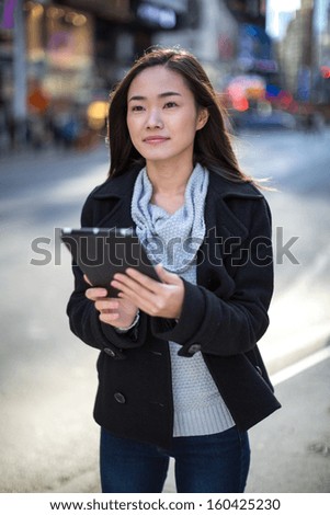 Asian woman using  tablet pc in New York City