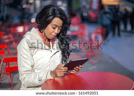 African American black cosmopolitan woman in New York City using tablet pc computer