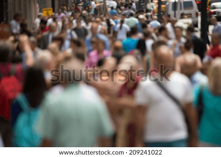 Crowd of people walking on street sidewalk in New York City