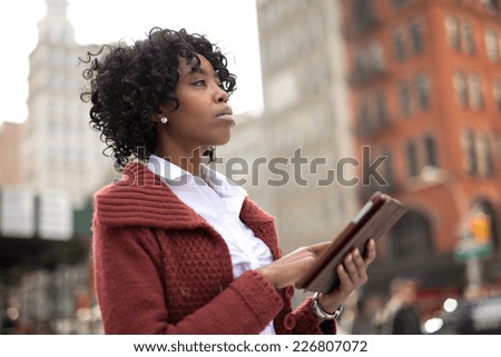 Young African American black woman in New York City using tablet pc computer