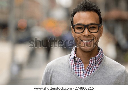 Young Black African Asian mixed man in city smile happy face portrait