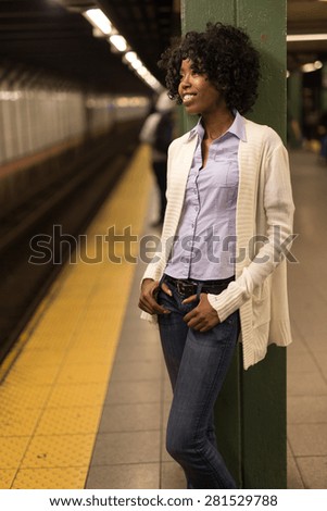 Young African American black woman in subway station platform