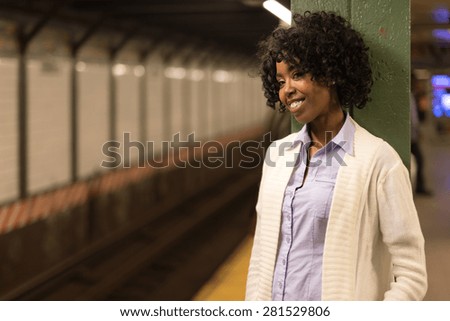 Young African American black woman in subway station platform