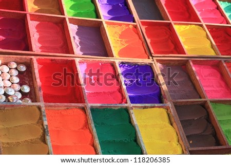 Set of organic pigment powders including various colors, from light green to dark brown passing through a series of red, yellow, pink, orange and violet. In Pashupatinath, Kathmandu, Nepal.