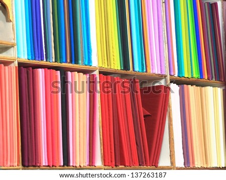 Shelves containing many solid color cloths-ranged by tones. Shop in the Kilagal District-Kathmandu-Nepal.