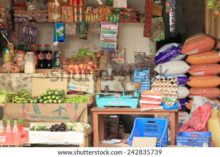 GODAWARI, NEPAL - OCTOBER 15: Grocery shop open to the street shows foodstuff items for sale along with blue painted old scales on October 15, 2012 in Godawari-Lalitpur distr.-Bagmati zone-Nepal.