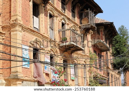 DHULIKHEL, NEPAL - OCTOBER 16: Traditional newar style houses show some ads on their red brick facades facing the old city area on October 16, 2012 in Dhulikhel-Kavrepalanchok dist.-Bagmati zone-Nepal