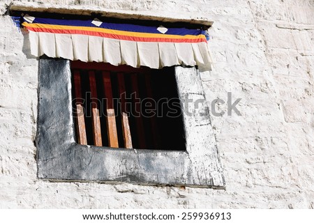 Small window with cross-arms on the white washed wall of the 1416 AD.founded Drepung monastery of the Gelugpa-Yellow Hat order at the foot of mount Ghephel. Lhasa pref.-Tibet A.R.-China.