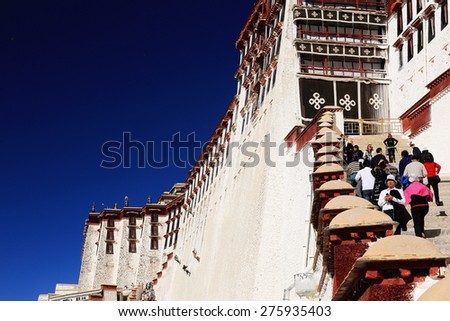 LHASA, TIBET, CHINA - OCTOBER 20: Locals and tourists climb the stairs leading to the inner Potala palace to visit the monument on October 20, 2012 in Lhasa-Tibet.