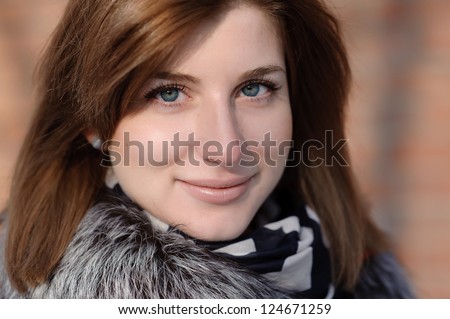 beautiful red-haired girl in winter clothes