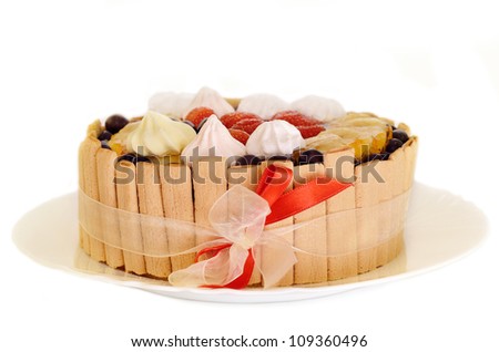 Birthday cake with strawberry, banana and red ribbon