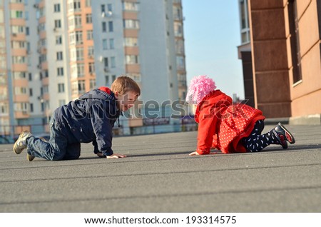 Happy brother and sister having fun in the street