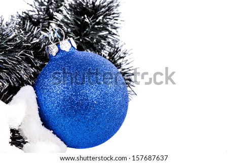 Christmas blue ball, star and garland on a white background close-up