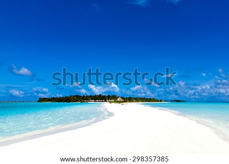 sea shallows leading to tropical island paradise with bungalows and palm trees on the Caribbean Maldivian Hawaii